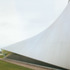 The roof sweeps to the ground in catenary-like curves