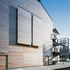 Green oak boarding clads the exterior acting, acting as a rain screen to the building