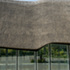 Thatched roof meeting glazed facade