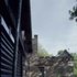 View onto existing stone house and decked outside area 