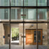 View from the reception space across the granite brick paved alley to the entrance arch
