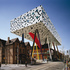 The table top is used to create a new sheltered public space, adjacent to the new student lounge in the existing building