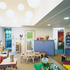 Clusters of paper lampshades hang from the sloping planes of the ceiling