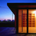 Living area lit at night with Dungeness B nuclear power station lit beyond