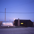 West facing elevation with Airstream caravan at dusk