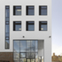 Exterior view of white render and glass curtain walling