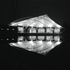 The building at night, reflected in the water below