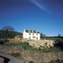The lawn is retained by precast-concrete stepped slabs forming a planted wall