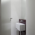 Bathroom with Alape resin-finished steel wash basin and back-painted glass