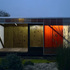 Private studio of the colour factory at night, the polycarbonate shell glowing with colour